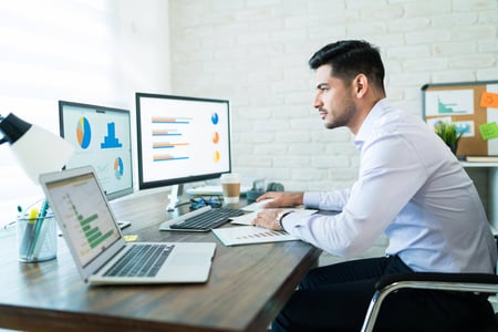 side-view-young-attractive-businessman-studying-charts-computer-while-working-home side-view-young-attractive-businessman-studying-charts-computer-while-working-home
